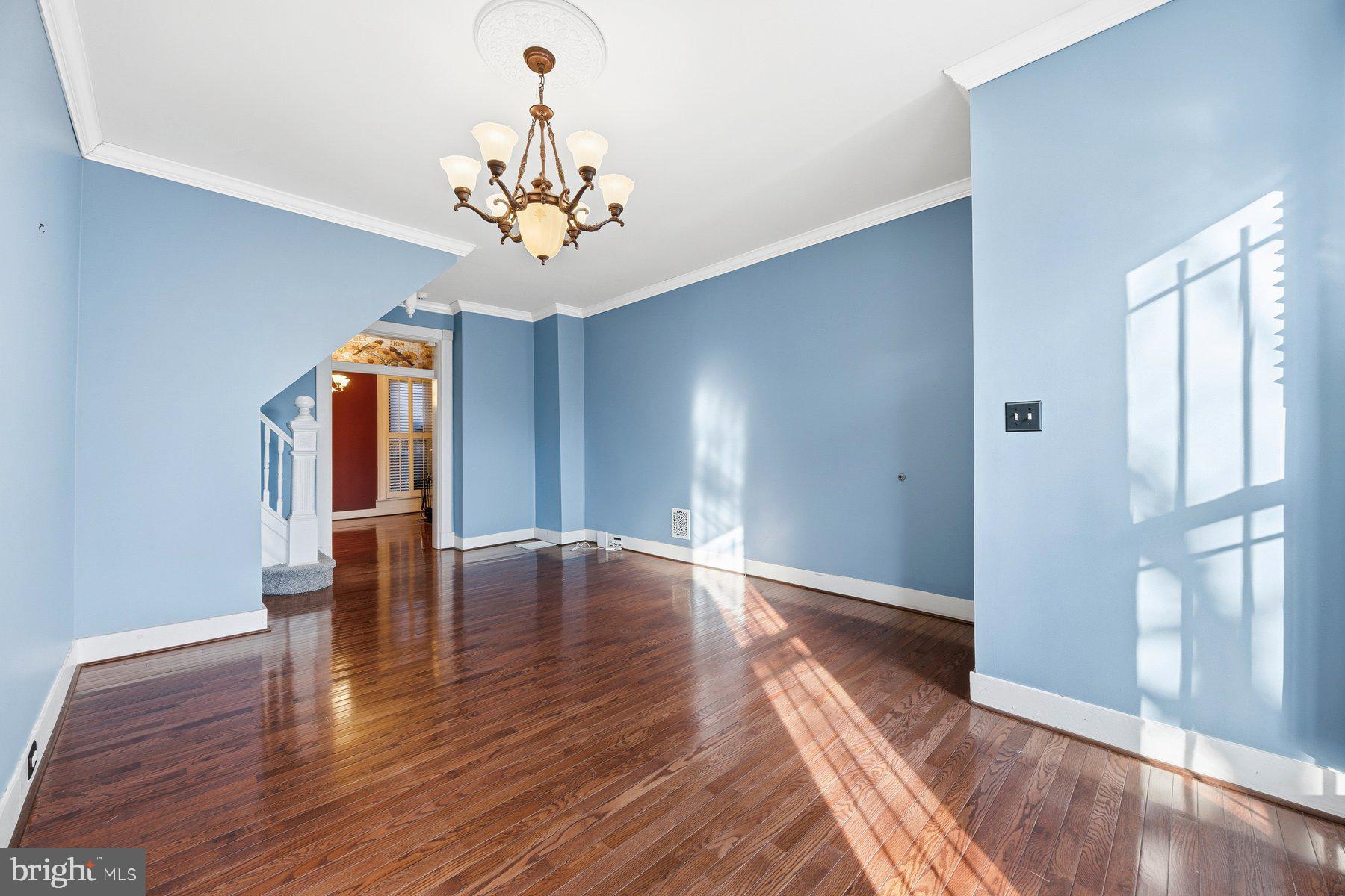 208 East Eager Street Baltimore, MD 21202 - Photo 5 of 31 a view of an empty room with wooden floor and a window