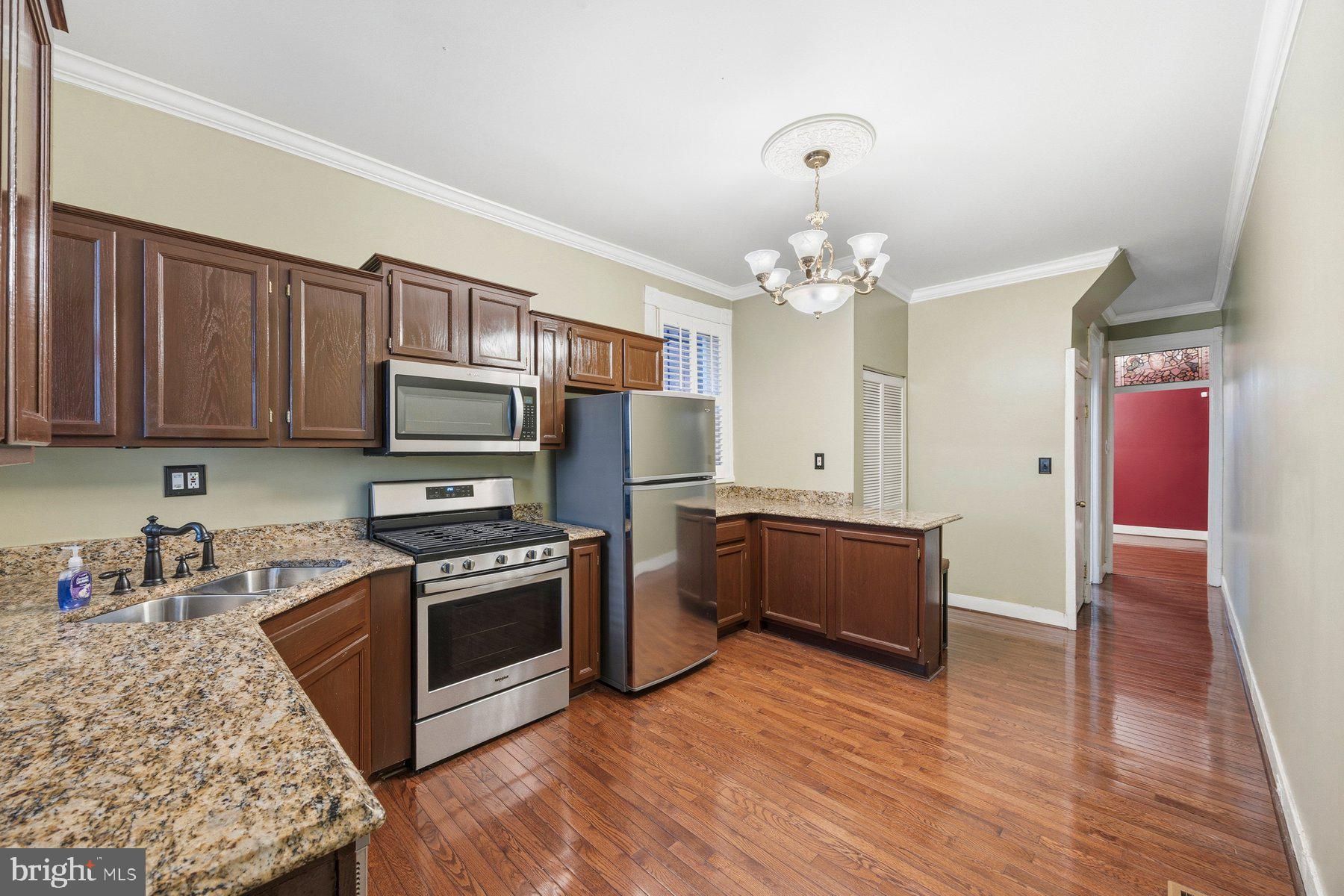 208 East Eager Street Baltimore, MD 21202 - Photo 6 of 31 a kitchen with granite countertop a stove top oven and cabinets