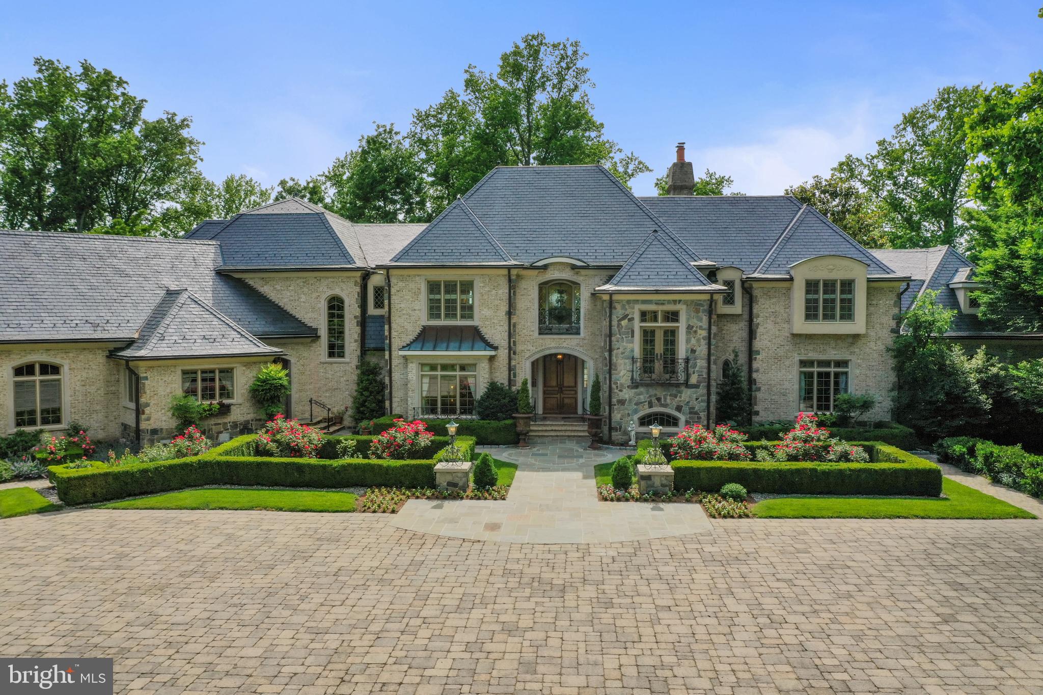 a front view of a house with a garden and plants