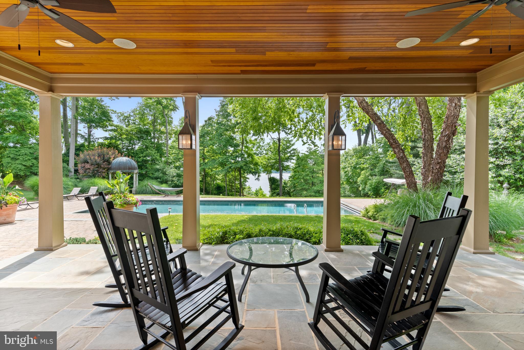 938 Old County Road Severna Park, MD 21146 - Photo 61 of 77 a view of a patio with a table chairs and a backyard