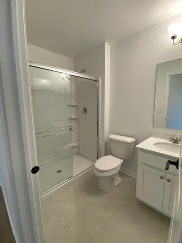 a bathroom with a shower toilet and sink