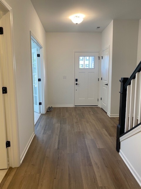 4515 Chelsea Mnr Circle, Unit 4515 Aurora, IL 60504 - Photo 2 of 37 an empty room with wooden floor and windows