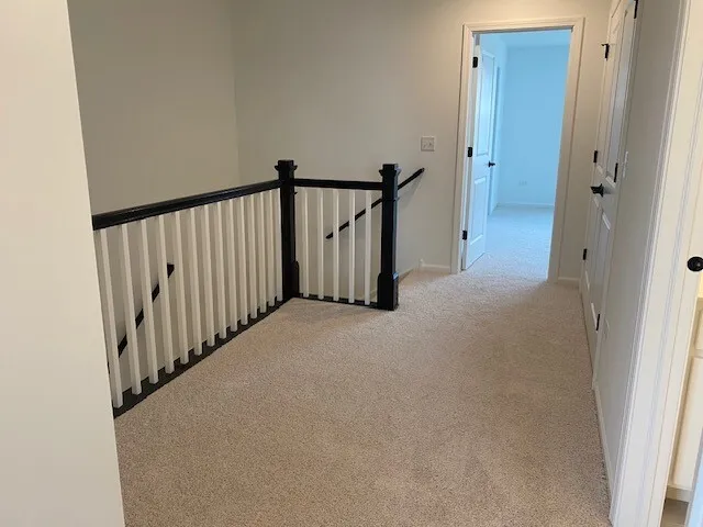 a view of a hallway with staircase