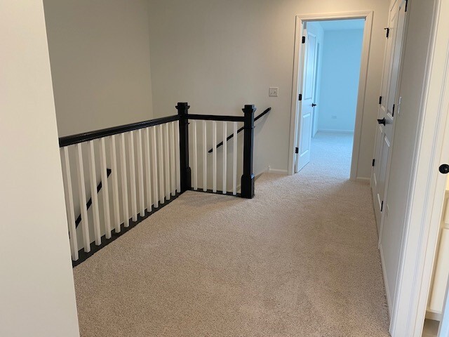4515 Chelsea Mnr Circle, Unit 4515 Aurora, IL 60504 - Photo 24 of 37 a view of a hallway with staircase