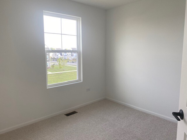 4515 Chelsea Mnr Circle, Unit 4515 Aurora, IL 60504 - Photo 25 of 37 an empty room with a window