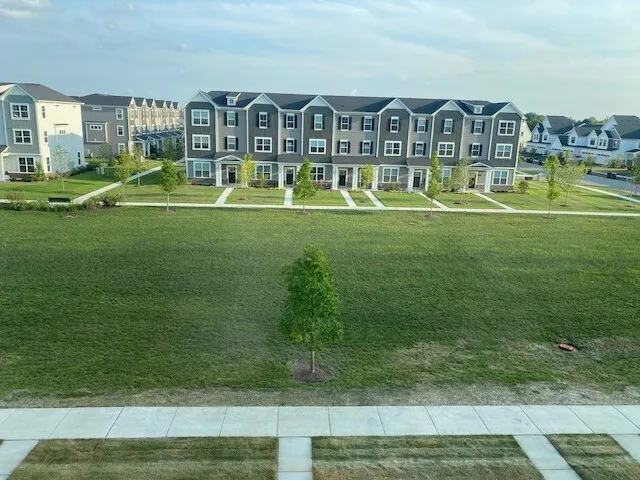 a front view of house with a play ground and trees