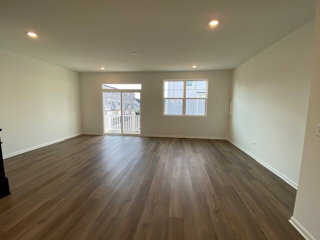 4515 Chelsea Mnr Circle, Unit 4515 Aurora, IL 60504 - Photo 5 of 37 an empty room with wooden floor and windows