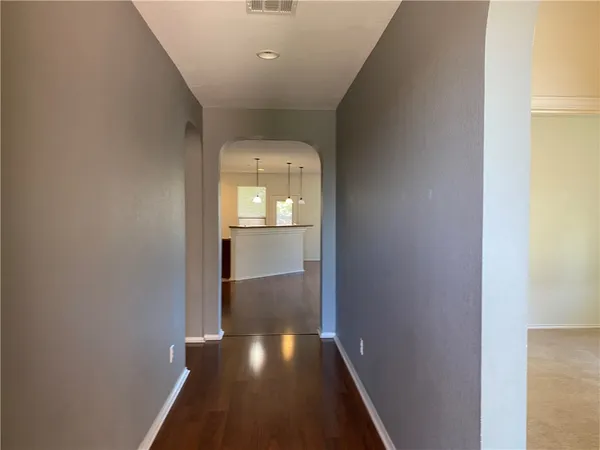 a view of hallway with wooden floor