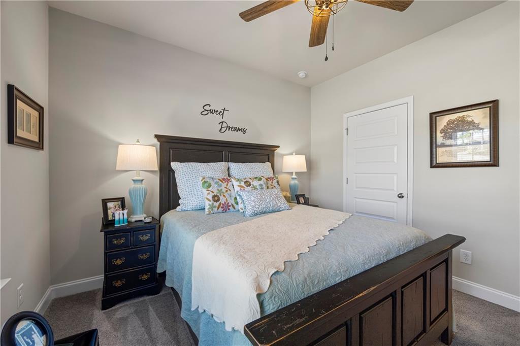 2347 Persimmon Chase Monroe, GA 30656 - Photo 18 of 85 a bedroom with a bed and a chandelier