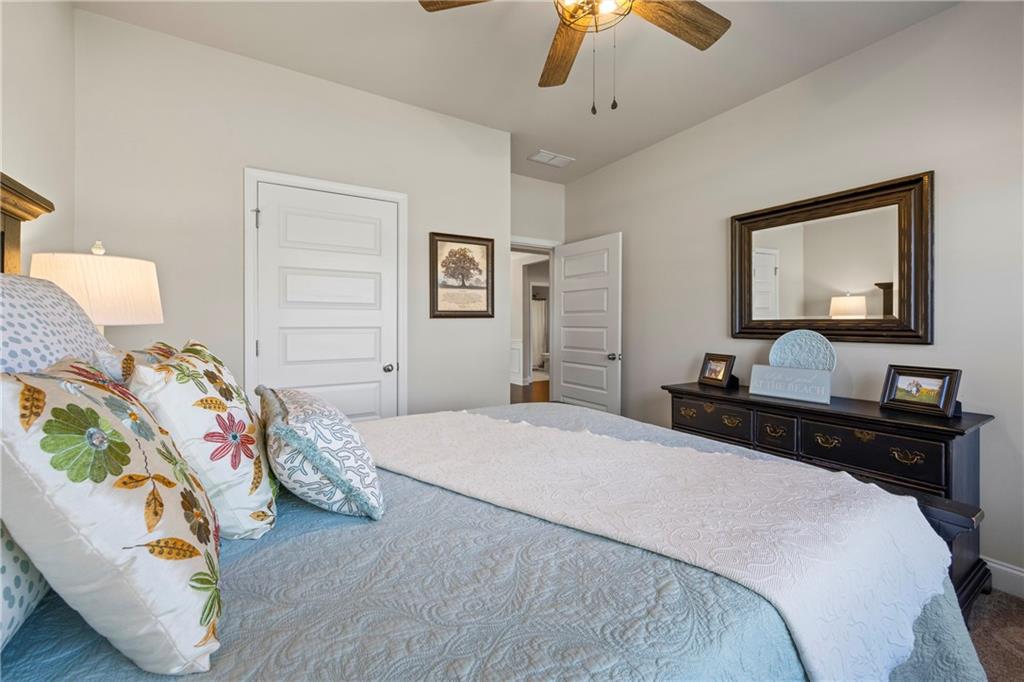 2347 Persimmon Chase Monroe, GA 30656 - Photo 19 of 85 a bedroom with a bed and a chandelier