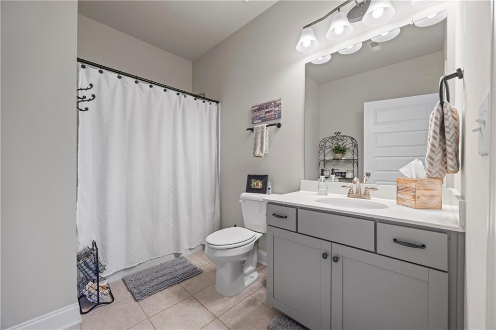 2347 Persimmon Chase Monroe, GA 30656 - Photo 21 of 85 a bathroom with a sink a toilet and shower curtain