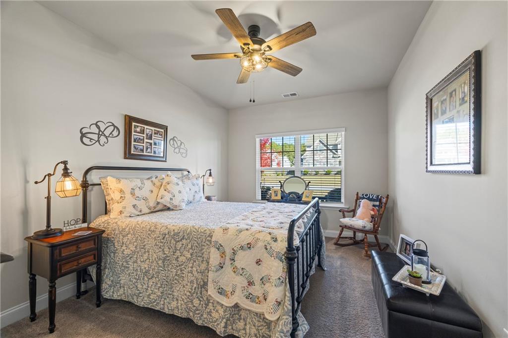 2347 Persimmon Chase Monroe, GA 30656 - Photo 22 of 85 a bedroom with a bed and a chandelier