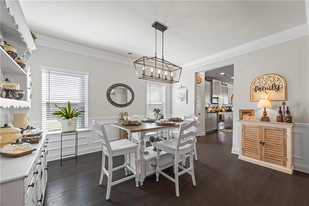 2347 Persimmon Chase Monroe, GA 30656 - Photo 26 of 85 a view of a dining room with furniture window and wooden floor