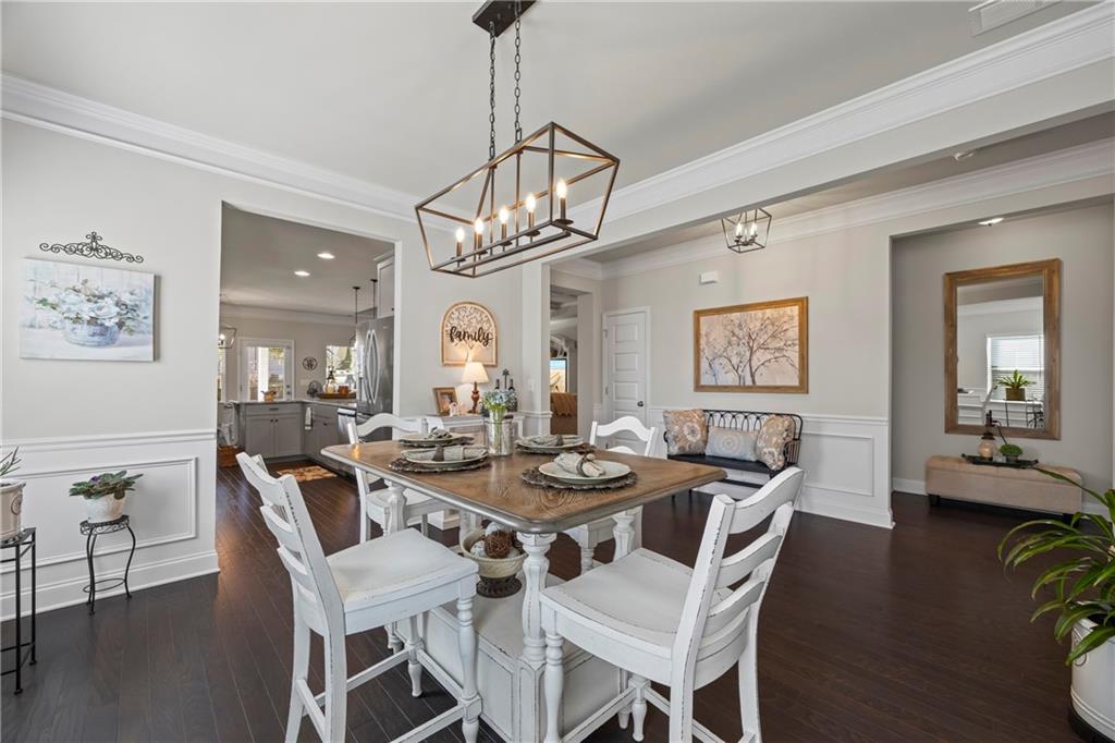 2347 Persimmon Chase Monroe, GA 30656 - Photo 28 of 85 a view of a dining room with furniture wooden floor and chandelier