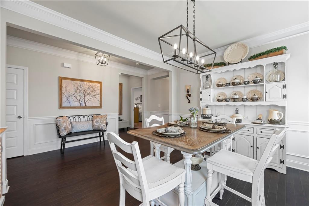 2347 Persimmon Chase Monroe, GA 30656 - Photo 30 of 85 a view of a dining room with furniture a chandelier and wooden floor