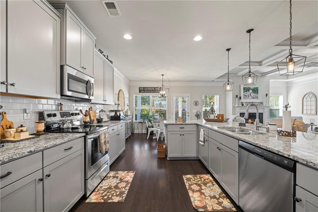 2347 Persimmon Chase Monroe, GA 30656 - Photo 32 of 85 a kitchen with lots of counter top space sink and stainless steel appliances