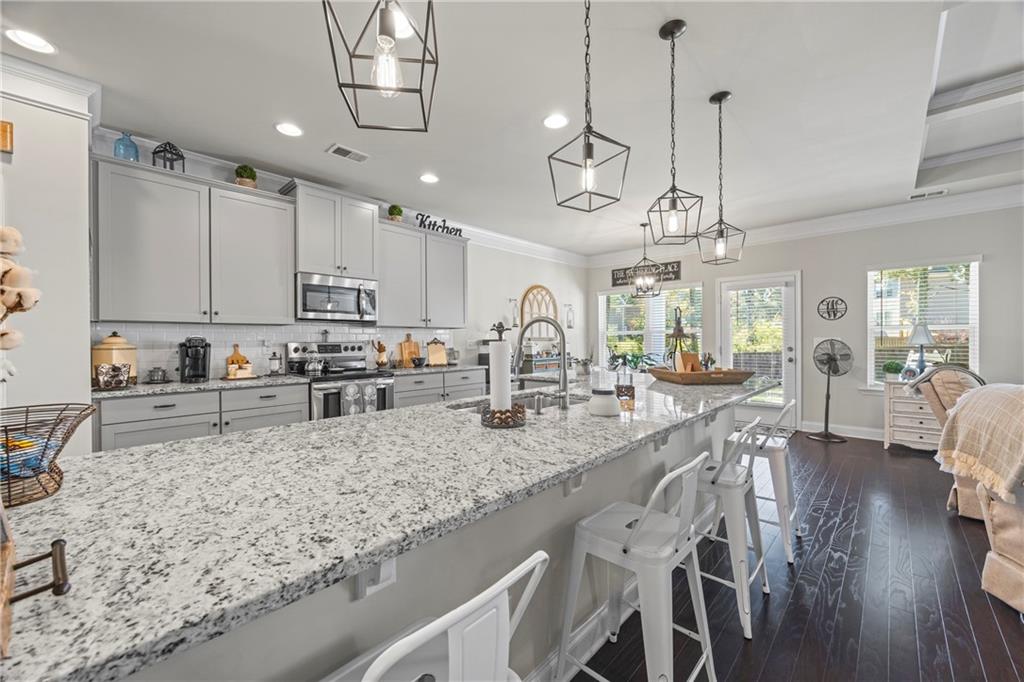 2347 Persimmon Chase Monroe, GA 30656 - Photo 42 of 85 a large kitchen with granite countertop lots of counter space a sink and appliances