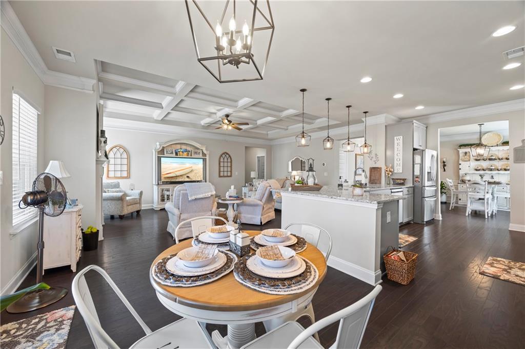 2347 Persimmon Chase Monroe, GA 30656 - Photo 44 of 85 a view of a dining room and livingroom with furniture wooden floor a chandelier