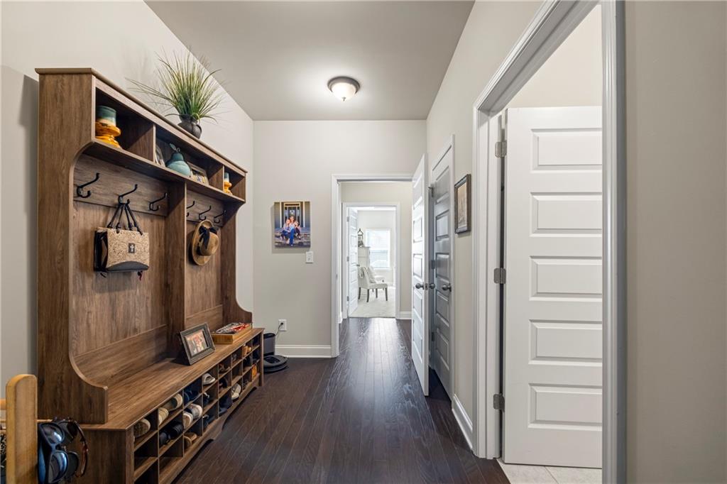 2347 Persimmon Chase Monroe, GA 30656 - Photo 63 of 85 a view of a hallway with wooden floor and closet