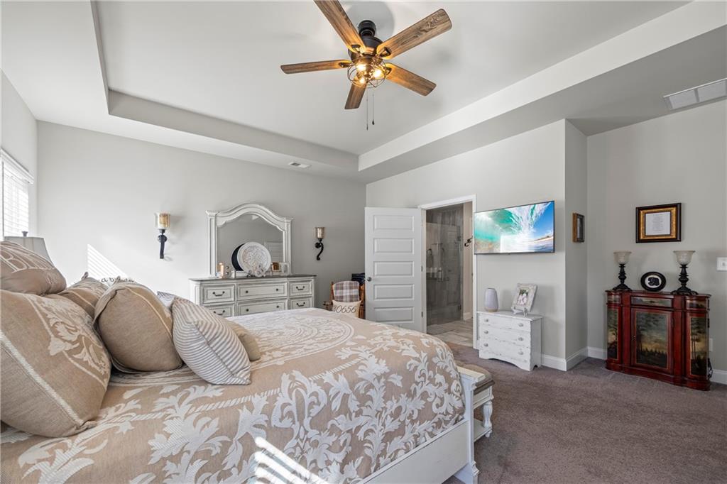 2347 Persimmon Chase Monroe, GA 30656 - Photo 68 of 85 a bedroom with a bed and a chandelier