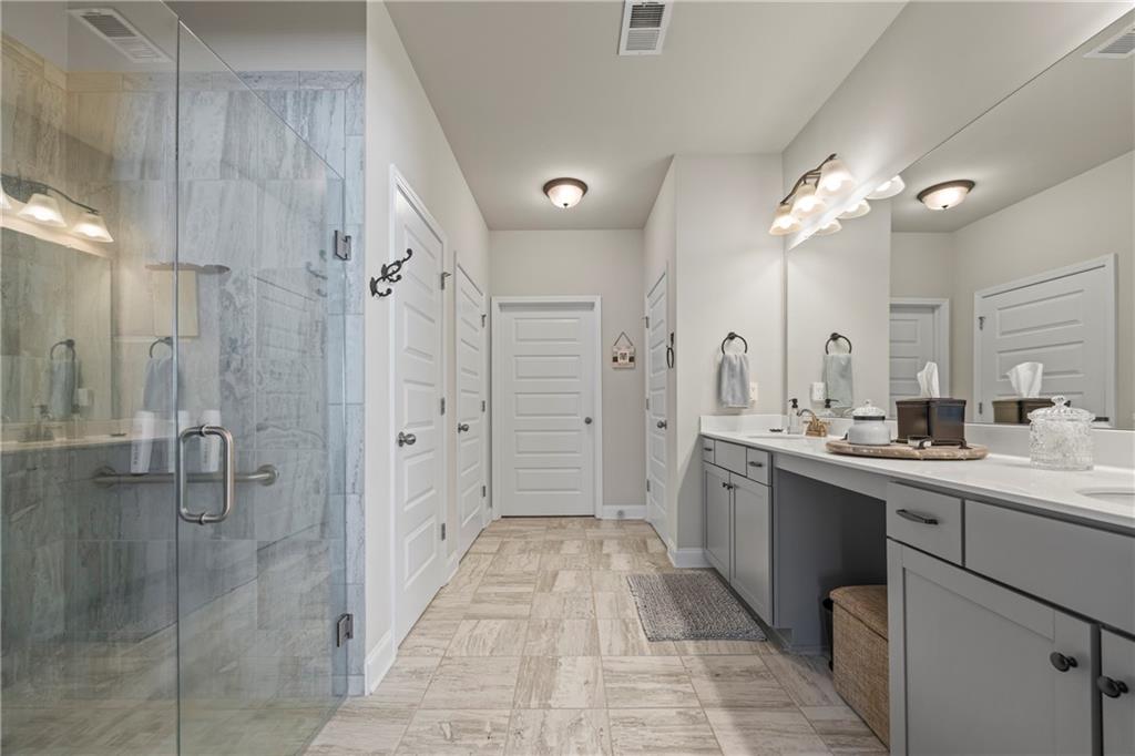 2347 Persimmon Chase Monroe, GA 30656 - Photo 70 of 85 a large bathroom with a double vanity sink mirror and shower