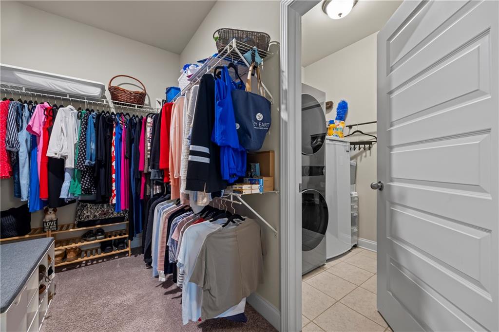 2347 Persimmon Chase Monroe, GA 30656 - Photo 78 of 85 a view of walk in closet with clothes and shoes