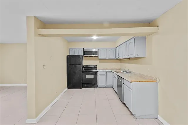 a kitchen with stainless steel appliances granite countertop a refrigerator and a stove