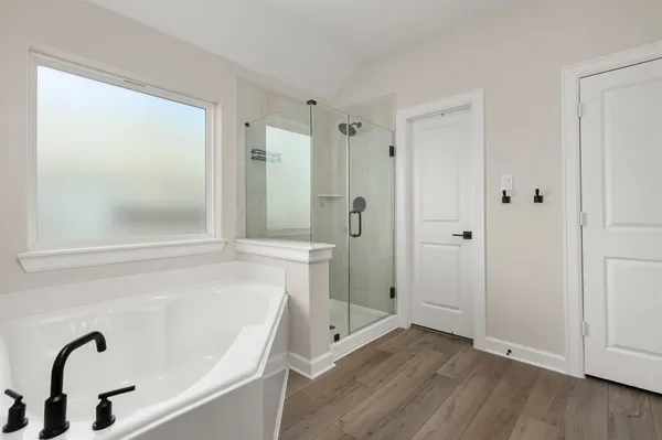 a bathroom with a tub shower and sink
