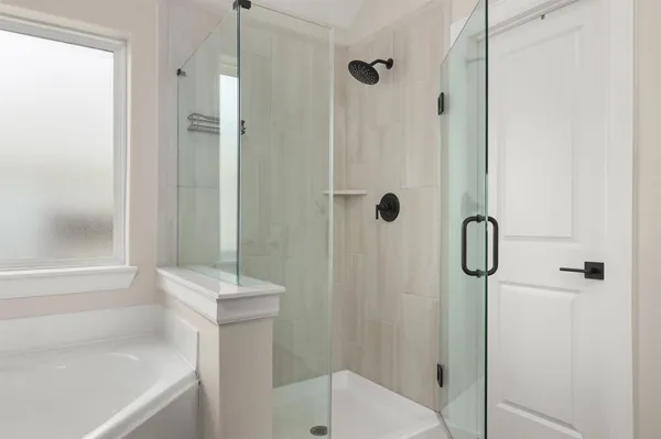 a bathroom with a shower and a tub