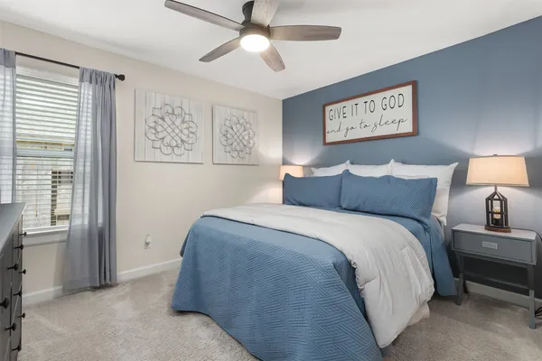 a bedroom with a bed and a painting on the wall