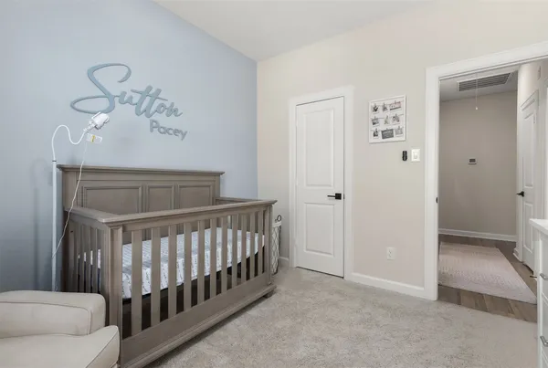 a view of a bedroom with wooden floor