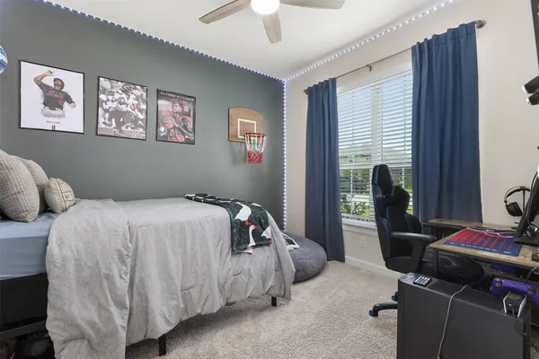 a bedroom with two beds and a chandelier