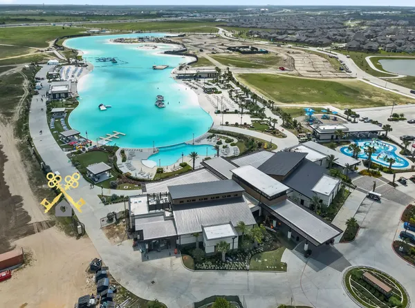 an aerial view of a swimming pool with a yard