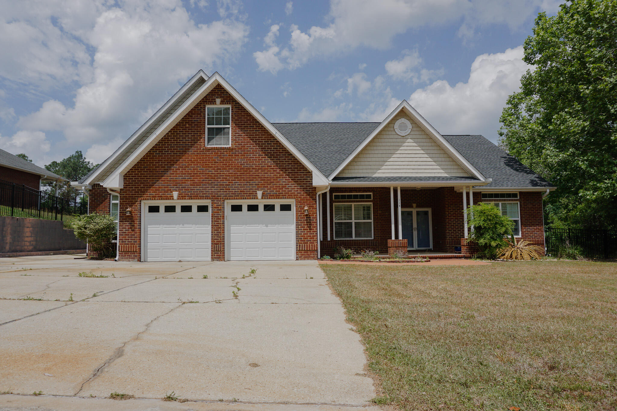 a front view of a house with a garden