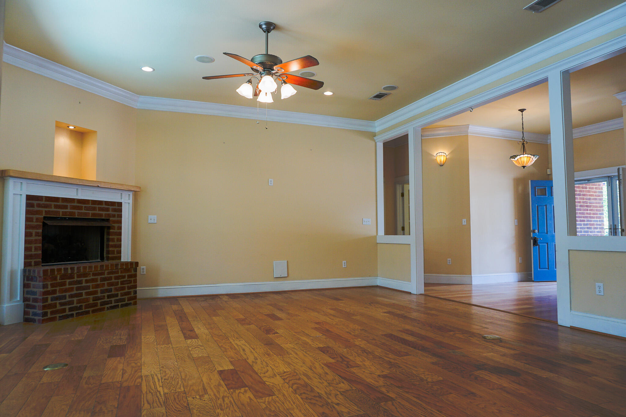 114 Eagle Drive Crestview, FL 32536 - Photo 5 of 63 a view of an empty room with wooden floor and a fireplace