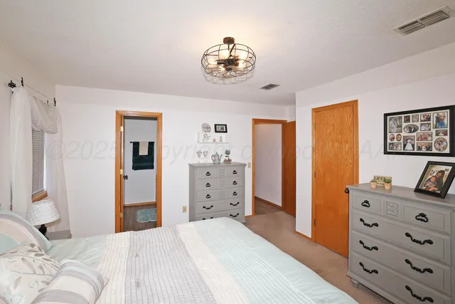 a bedroom with a bed and a dresser in it