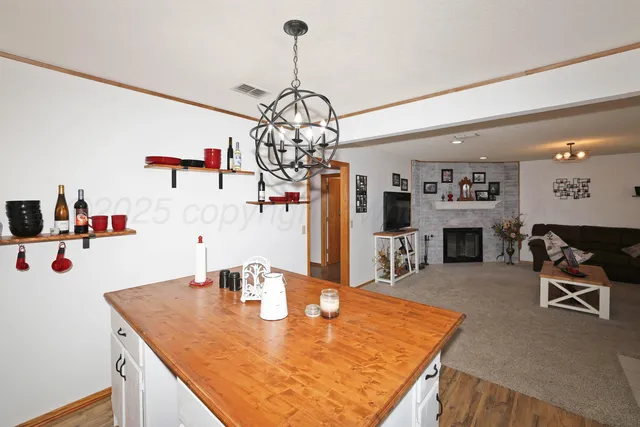 a dining table with a refrigerator a kitchen island a table and chairs in it
