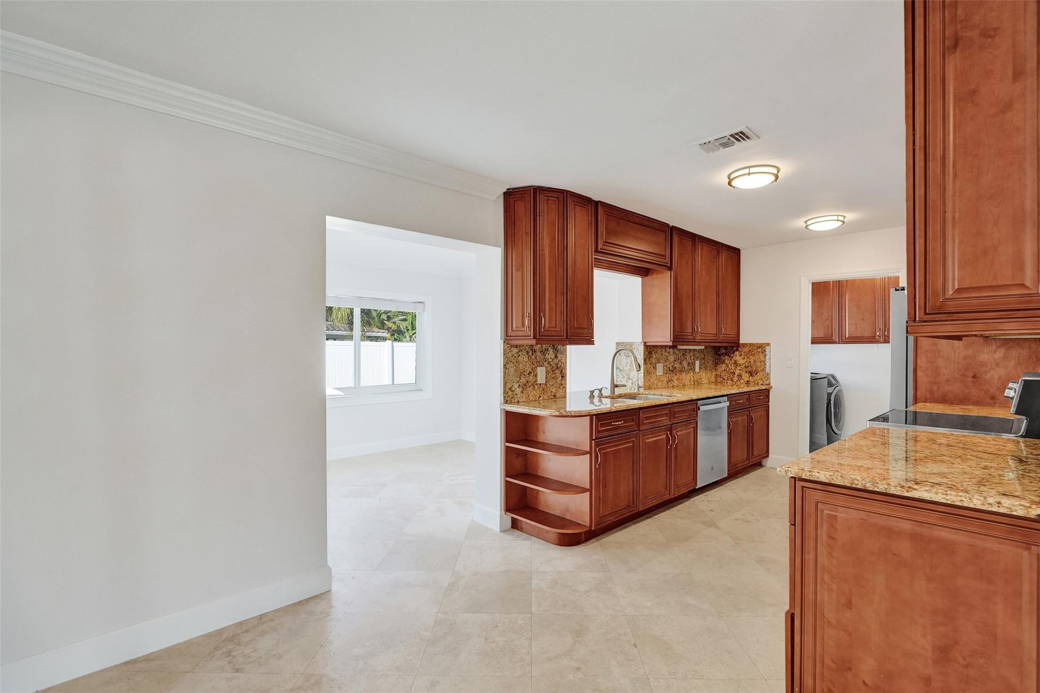 2011 Northeast 34th Street Lighthouse Point, FL 33064 - Photo 18 of 47 a kitchen with a refrigerator and a stove top oven