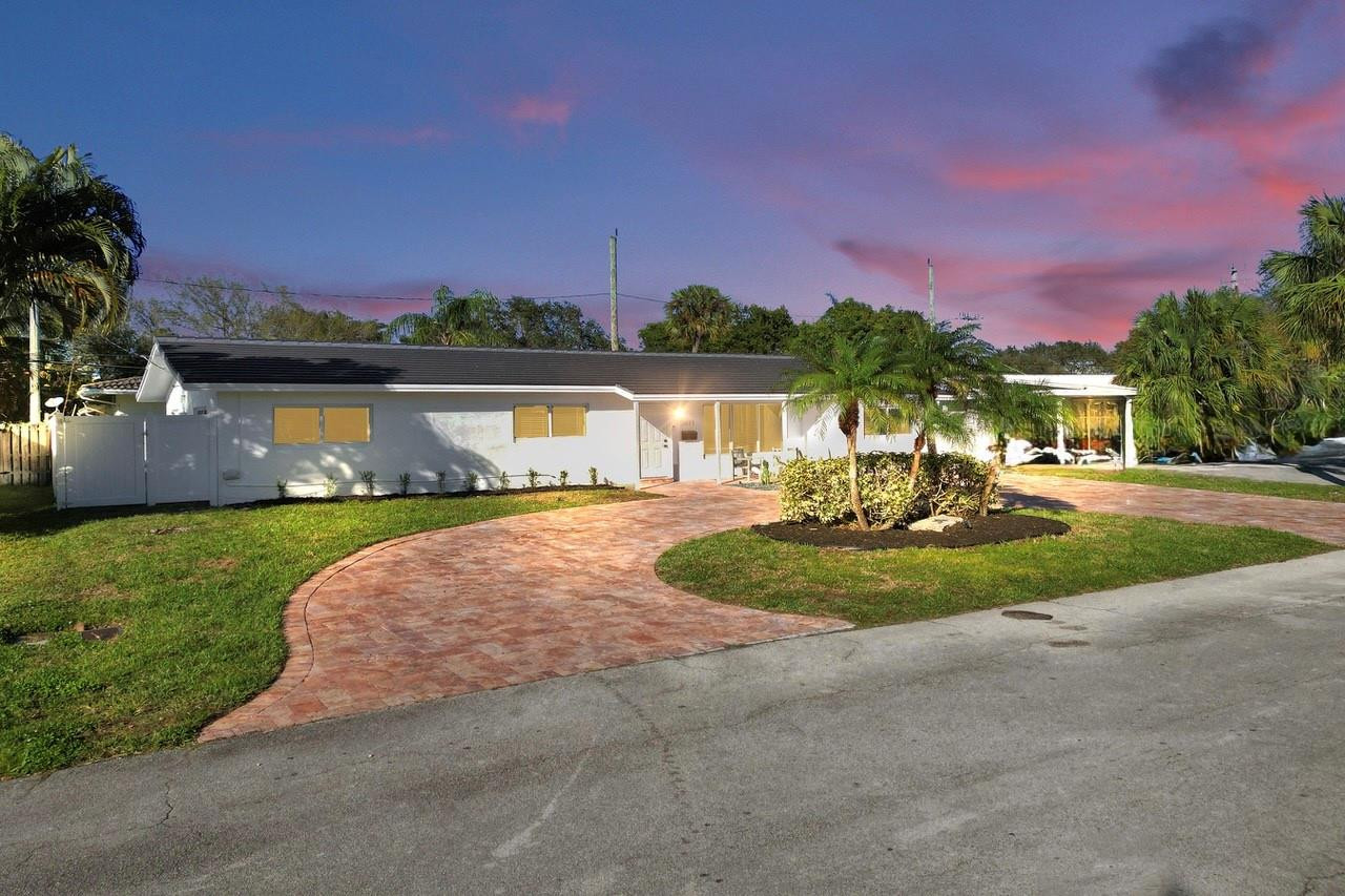 2011 Northeast 34th Street Lighthouse Point, FL 33064 - Photo 2 of 47 a view of a patio with swimming pool and a yard
