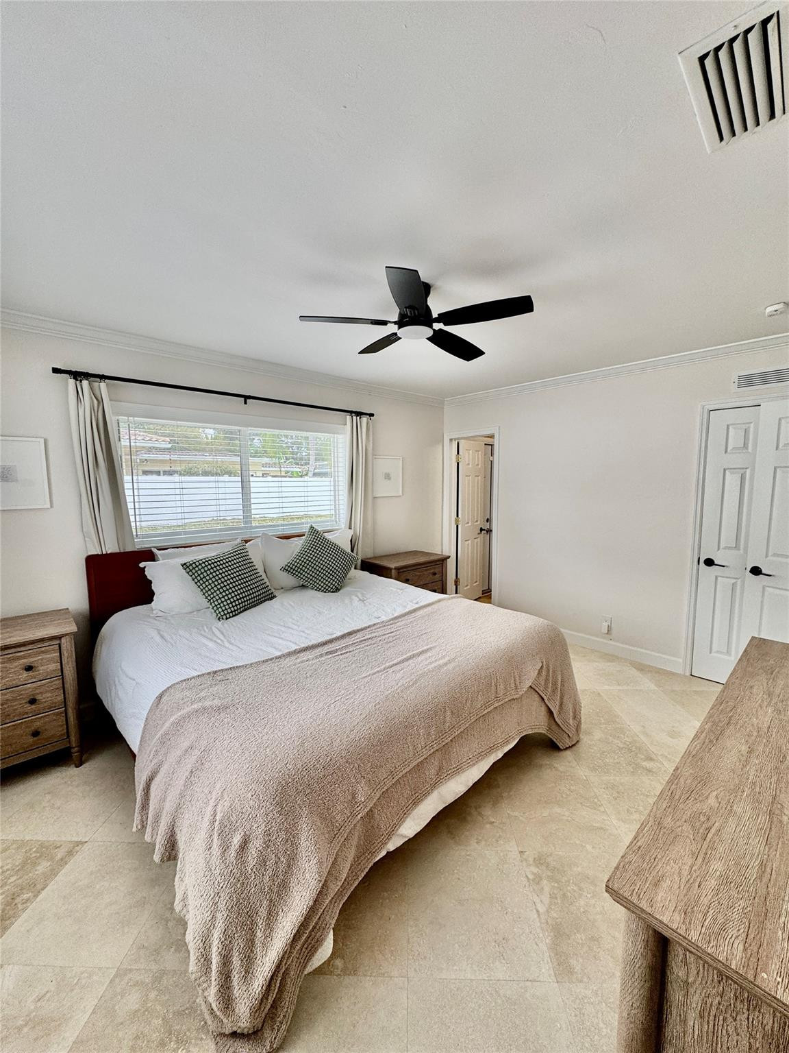 2011 Northeast 34th Street Lighthouse Point, FL 33064 - Photo 27 of 47 a bedroom with a bed and a chandelier