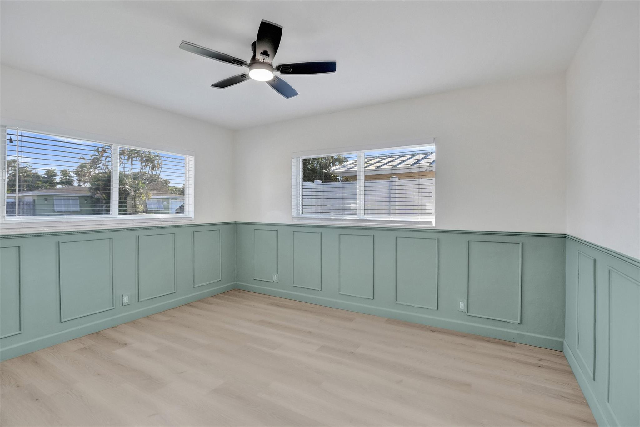 2011 Northeast 34th Street Lighthouse Point, FL 33064 - Photo 32 of 47 a view of a livingroom with a ceiling fan & cabinets