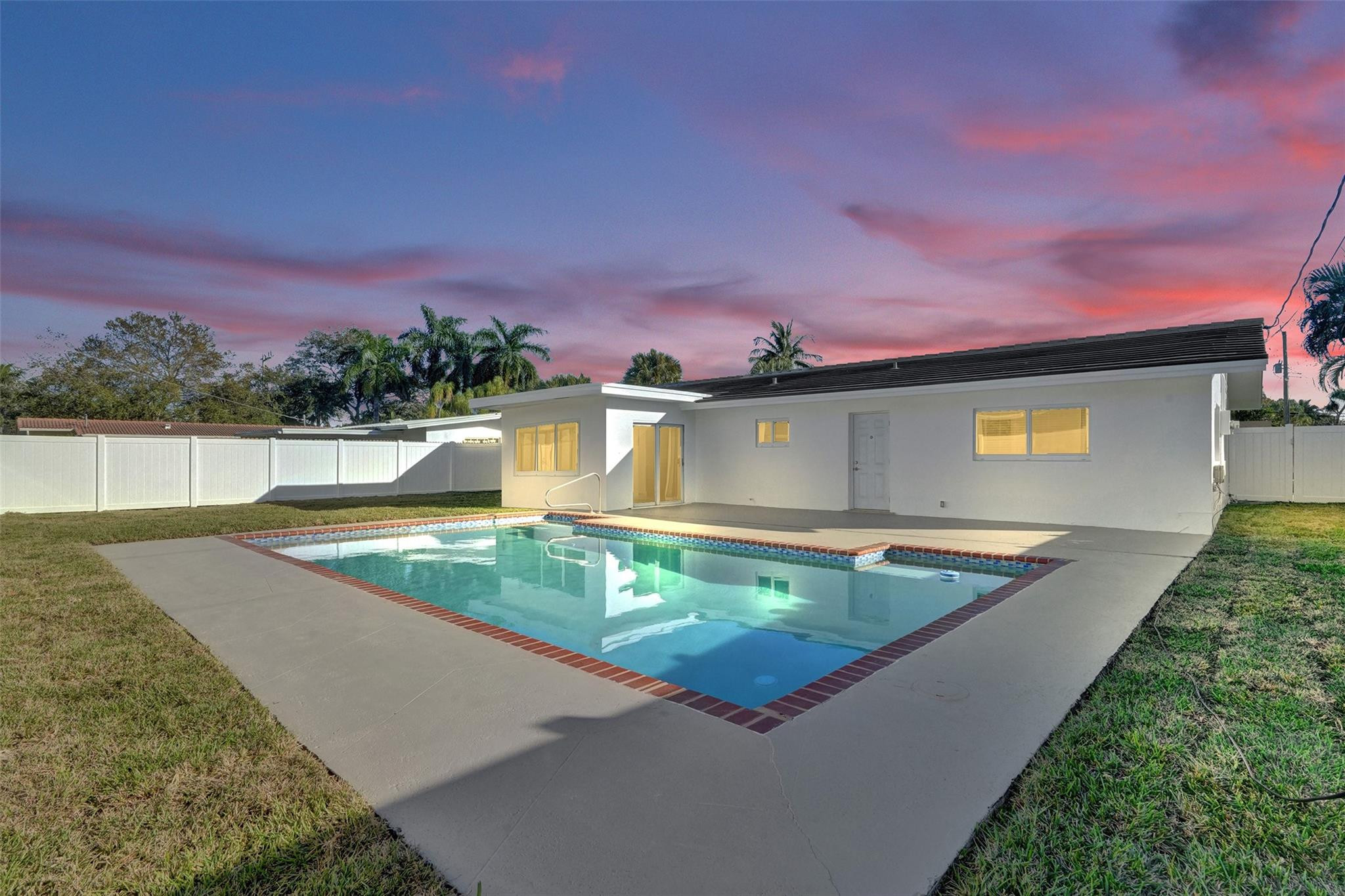 2011 Northeast 34th Street Lighthouse Point, FL 33064 - Photo 44 of 47 a view of a swimming pool with a yard and a fire pit