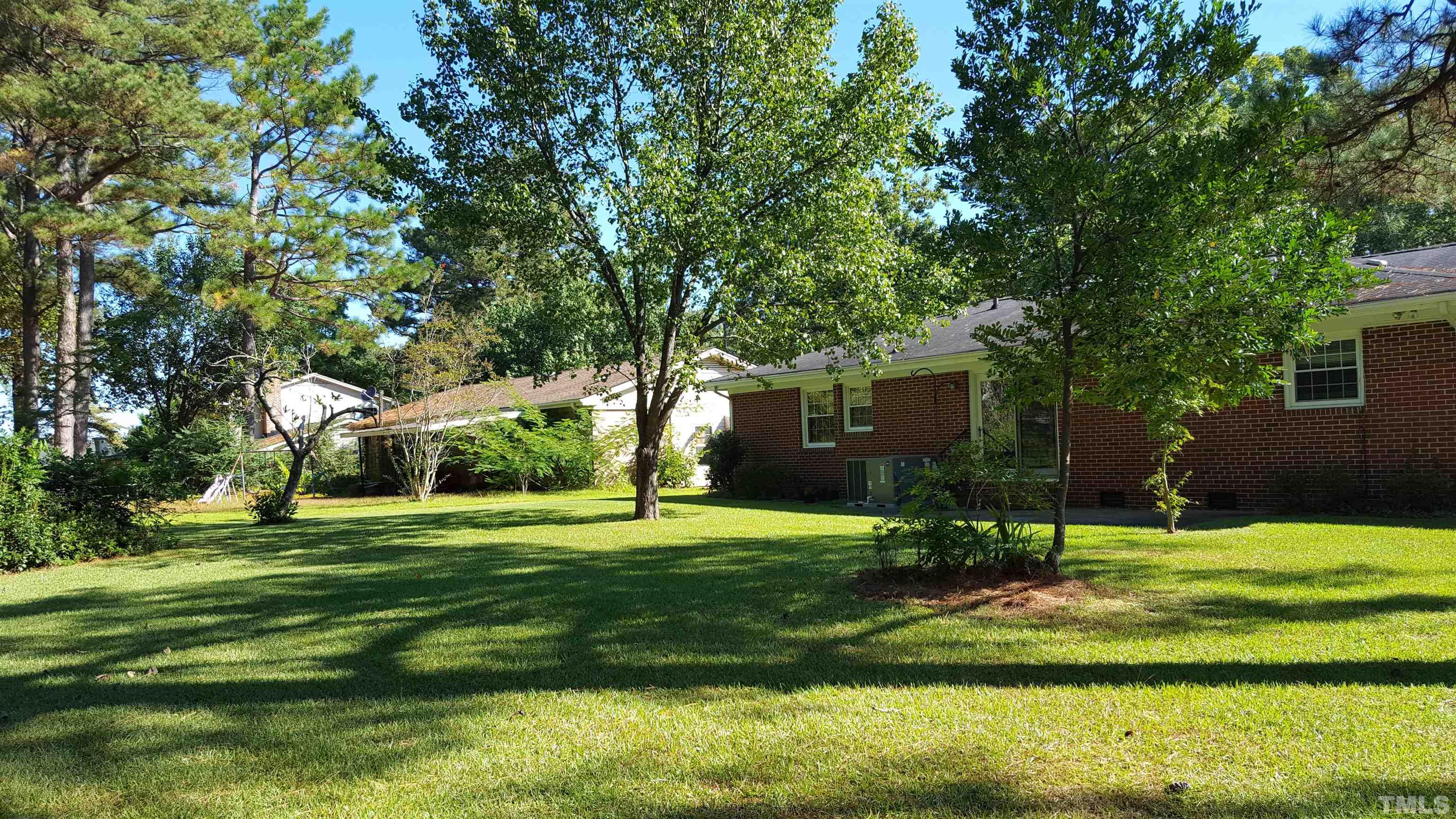 212 Longview Drive Smithfield, NC 27577 - Photo 13 of 15 a view of a house with a big yard and large trees