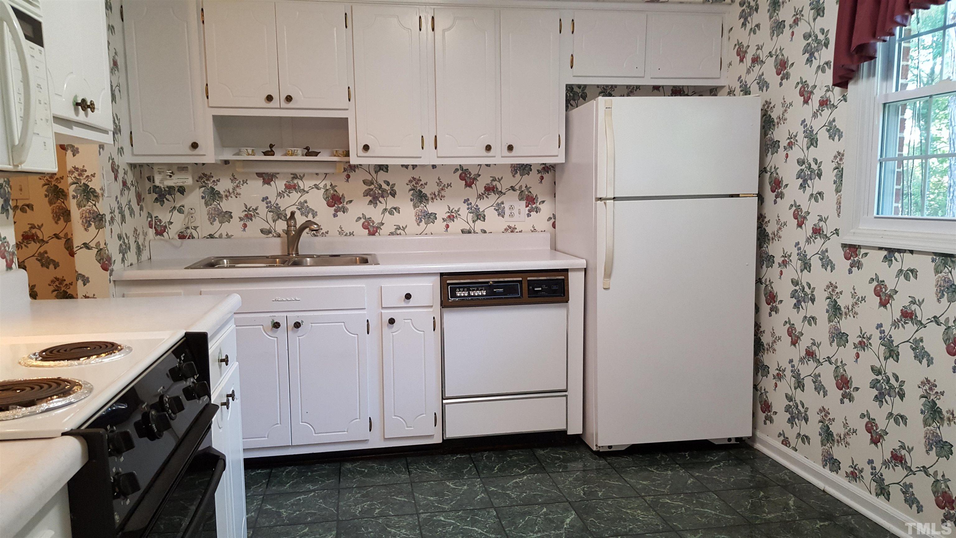 212 Longview Drive Smithfield, NC 27577 - Photo 9 of 15 a view of kitchen with white cabinets and white appliances