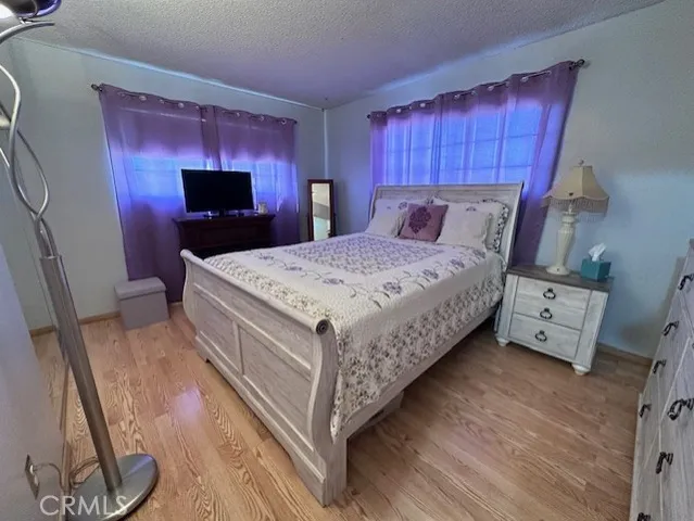 a bed room with a bed and a television