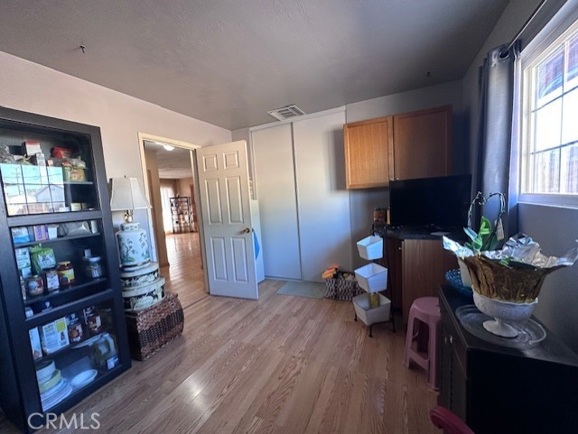 25478 Ash Road Barstow, CA 92311 - Photo 16 of 35 a living room with furniture and a book shelf