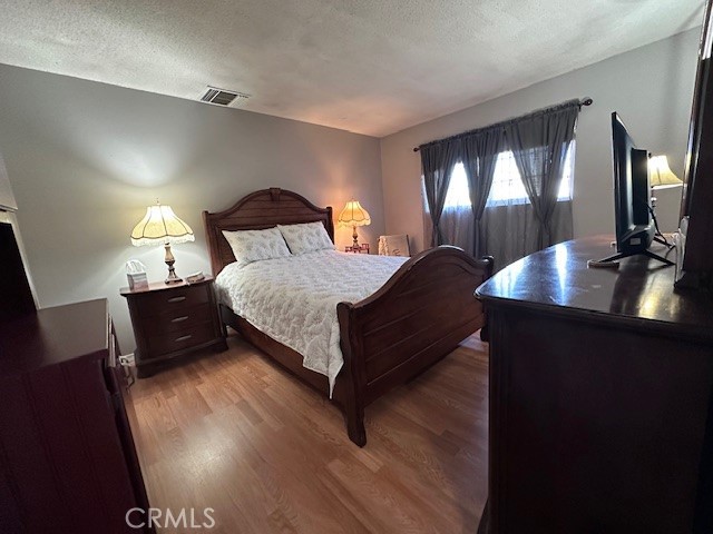 25478 Ash Road Barstow, CA 92311 - Photo 17 of 35 a bed room with a bed and a night stand
