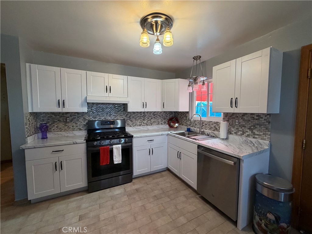 25478 Ash Road Barstow, CA 92311 - Photo 23 of 35 a kitchen with a stove and a sink