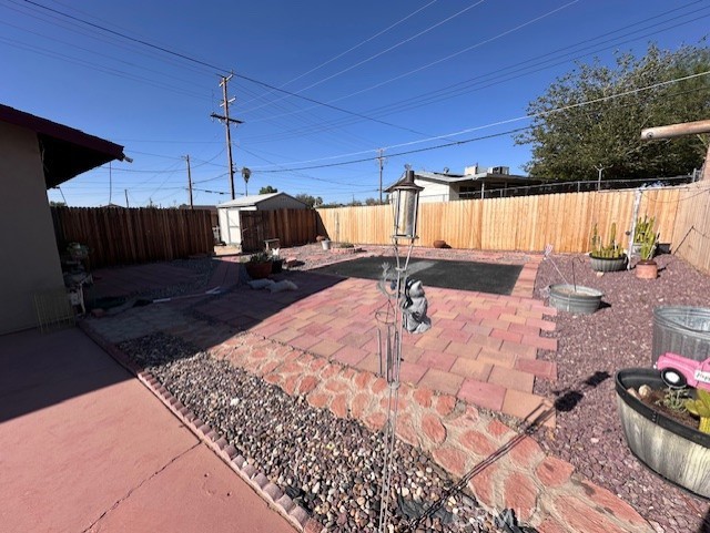 25478 Ash Road Barstow, CA 92311 - Photo 26 of 35 a view of a backyard with table and chairs under an umbrella