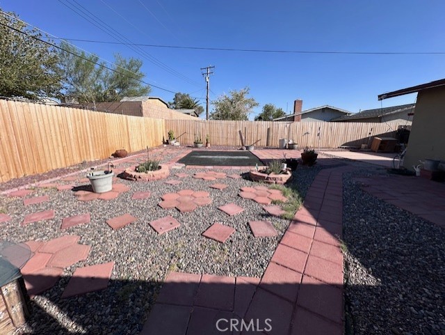 25478 Ash Road Barstow, CA 92311 - Photo 28 of 35 a view of a backyard with a patio and outdoor seating